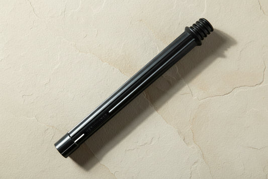 Black cartridge housing lying on flagstone
