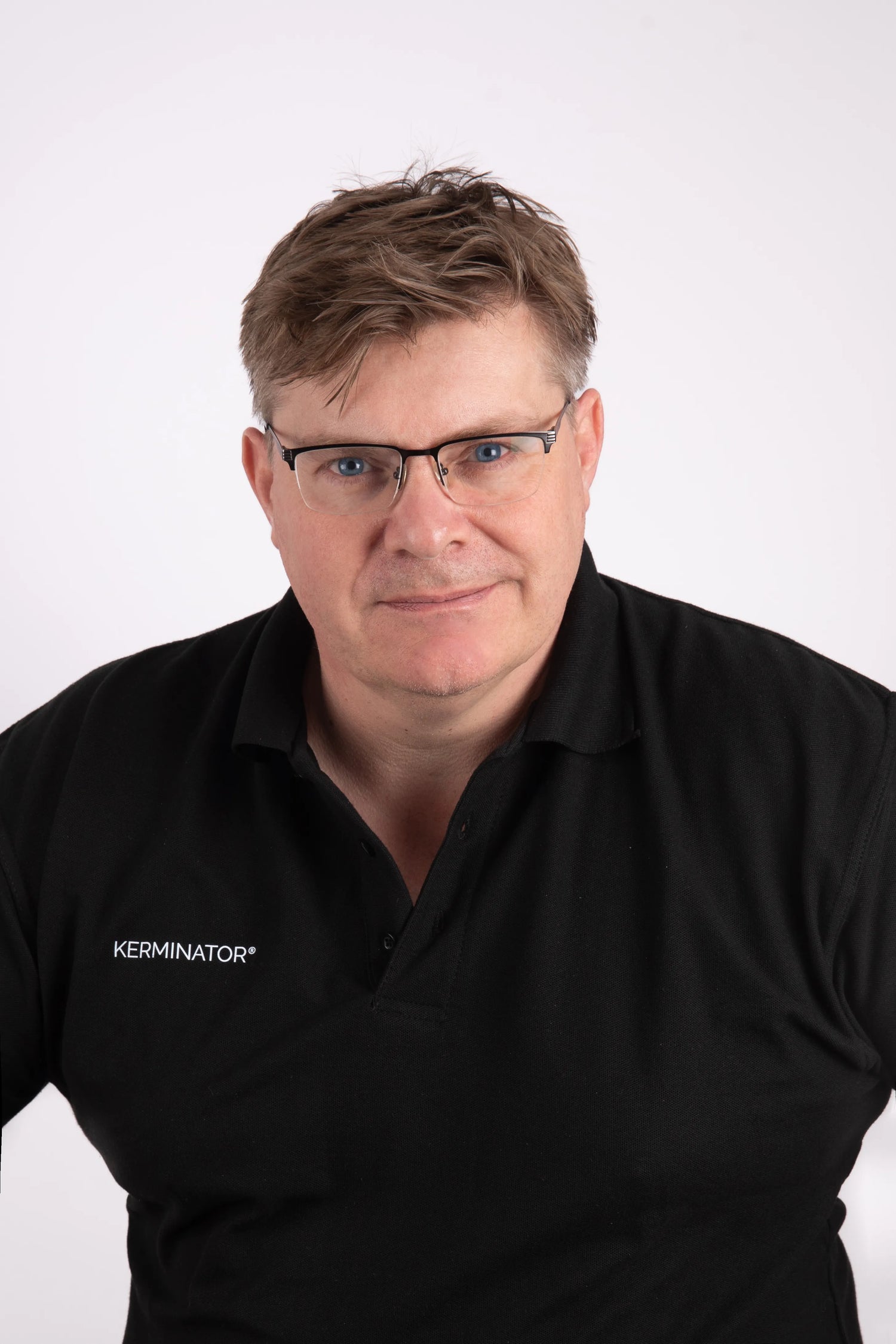 Kerminator creator wearing a black shirt with 'Kerminator' logo on a white background