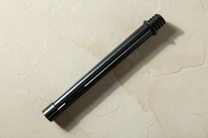 Black cartridge housing lying on flagstone