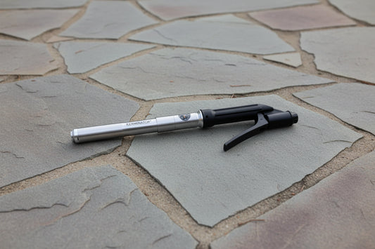top down view of the Kerminator hand valve and pump on textured outdoor surface